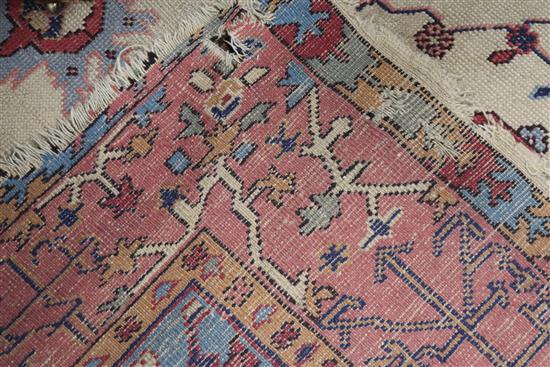 A Turkey pink and cream medallion carpet (worn in places and frayed at one end) 410 x 313cm